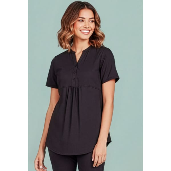 A women's black tunic scrub top with short sleeves, featuring a button placket and a slight pleat.