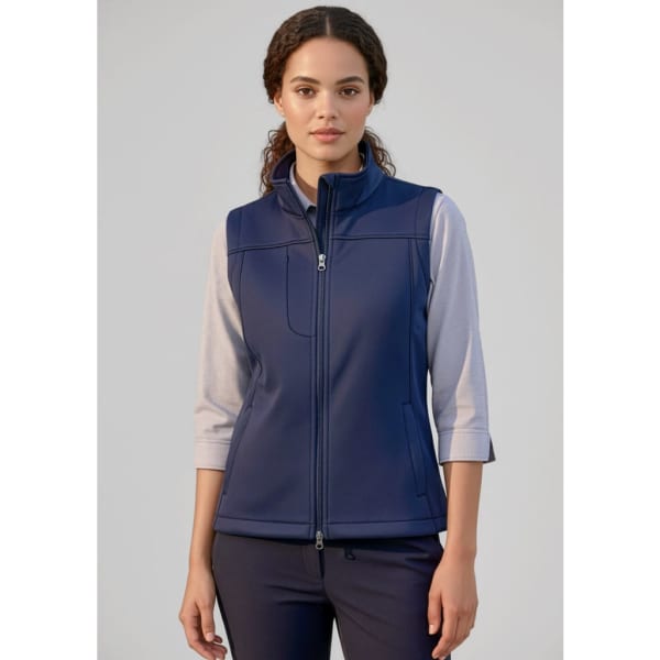 A women's softshell vest in navy blue with a zip-up front, featuring a collar and a logo on the chest.