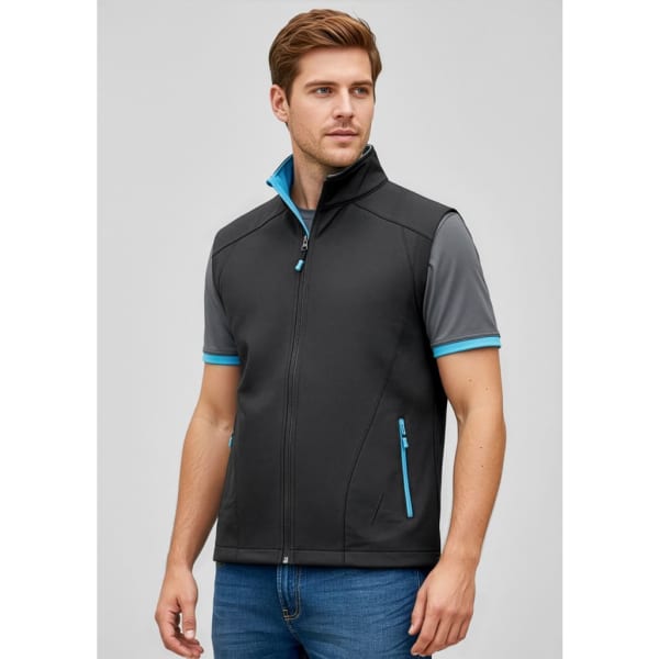 A man wears a black vest with grey and teal accents, featuring a zip closure and pockets. Branding visible.