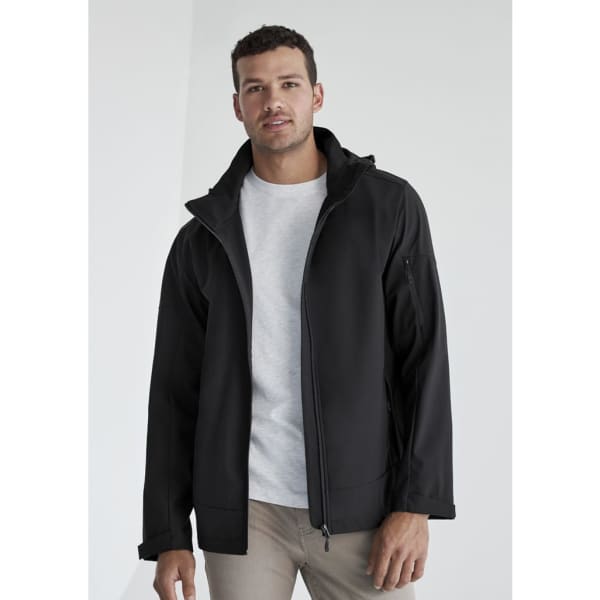 A man wearing a black rain jacket with a hood, featuring a zip-up front and a logo.