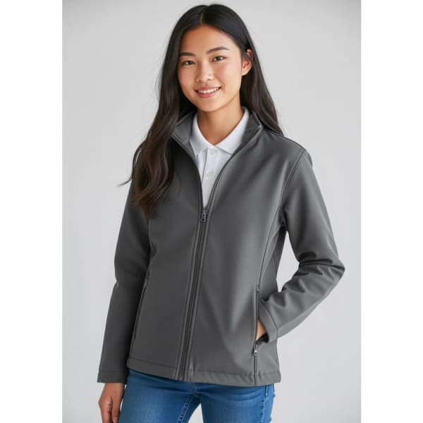 A grey Kids Apex Jacket features a zip-up front and a collar, modelled by a young person in casual attire.