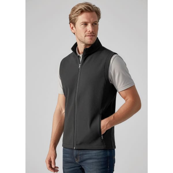 A fitted black men's vest with a zip front and side pockets, worn over a light-coloured t-shirt.