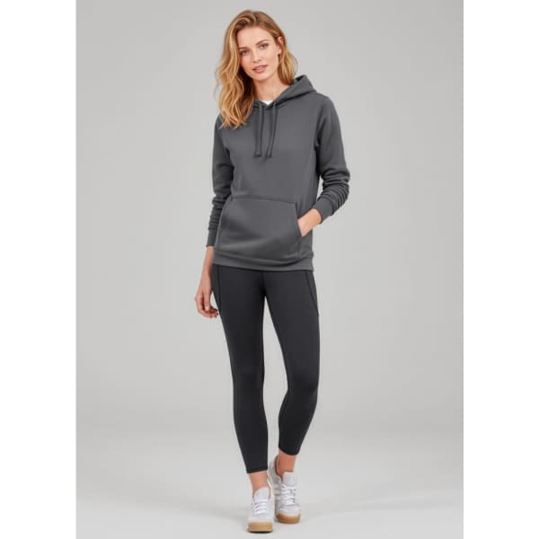 A model wearing grey Women's Luna 7/8 length leggings paired with a matching grey hoodie and white sneakers.