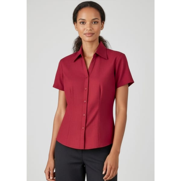 A short-sleeve, button-up shirt in a rich burgundy colour with a fitted silhouette and a collar.