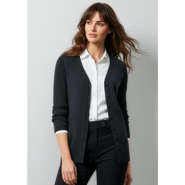 A dark grey women's cardigan with buttons, styled over a white shirt and paired with black trousers.