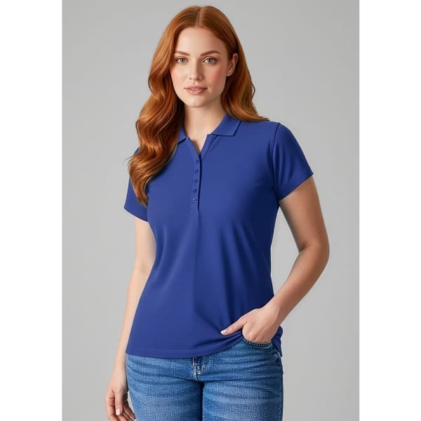 A blue polo shirt for ladies, featuring a collar and buttons, displayed on a model with long, wavy red hair.