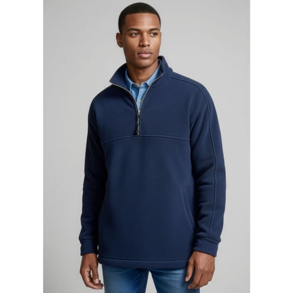 A man wearing a navy blue heavy-weight fleece jumper with a zip collar, featuring a logo on the chest.