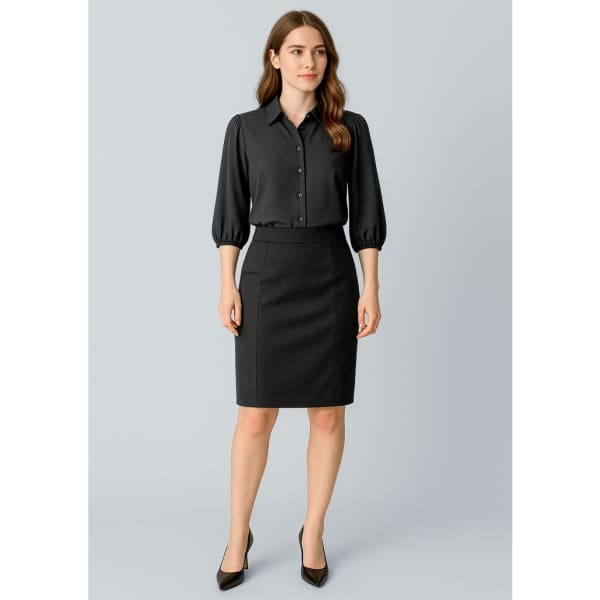A woman is wearing a black mid-waist pencil skirt paired with a black button-up shirt and heels.