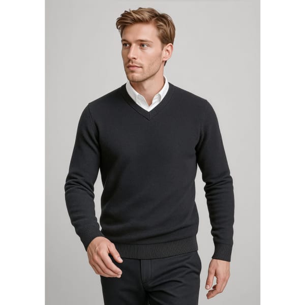 A knitted jumper in black, featuring a v-neck and ribbed cuffs, modelled by a man against a light background.