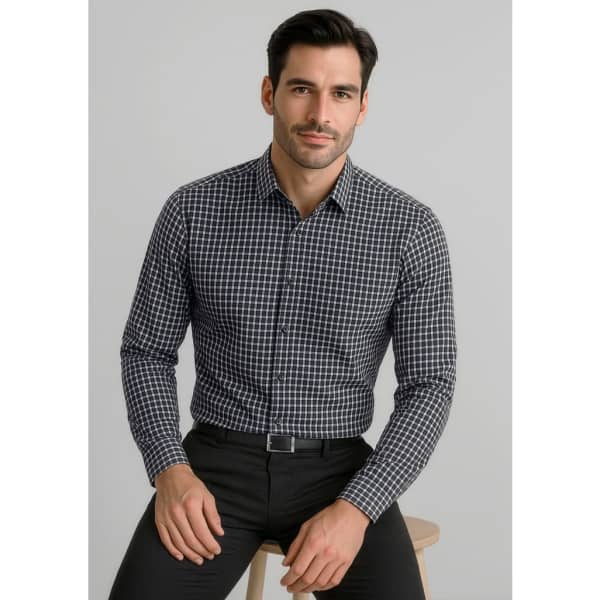A black and white checkered long sleeve button-up shirt on a model, paired with dark trousers. The shirt features a logo.