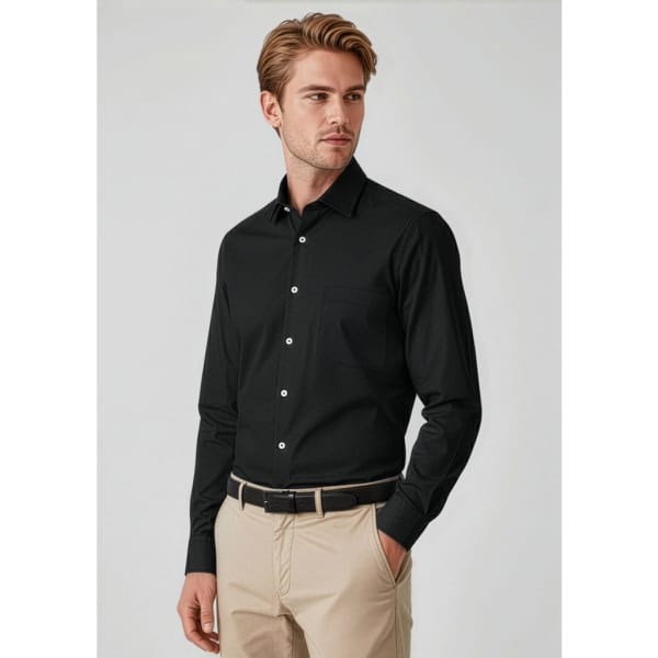 A black long sleeve button-up shirt on a model, paired with beige trousers, featuring a subtle logo.