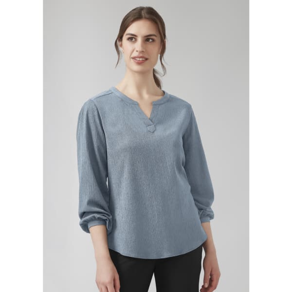 A blue women's long sleeve blouse with a V-neck and ruché detailing. The fabric has a textured look.