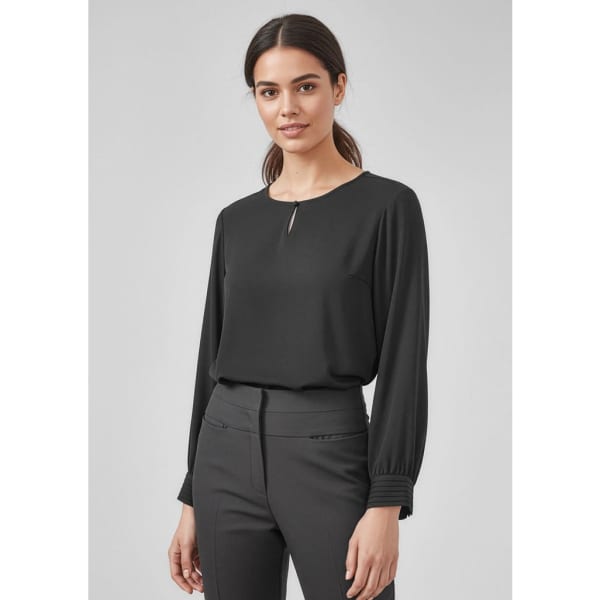 A black long sleeve blouse with a round neckline and subtle pleat detail, paired with dark trousers.