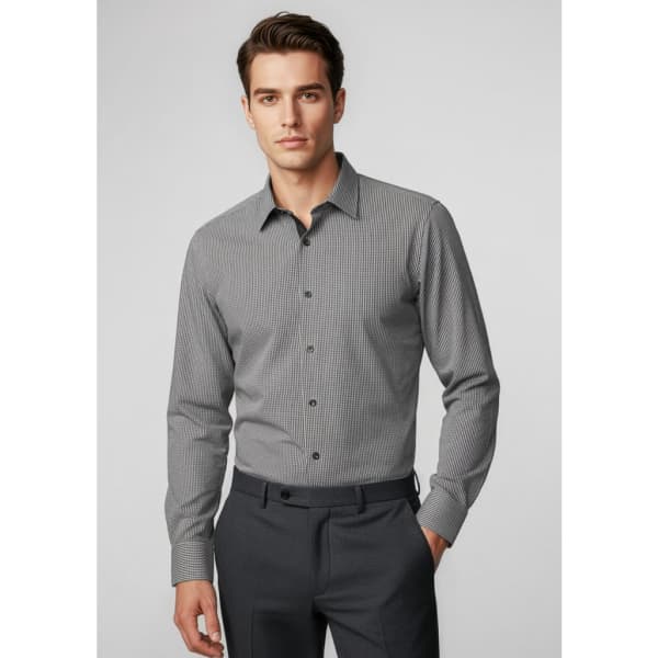 A long-sleeve, button-up shirt in grey check pattern, worn by a model with dark trousers. Features a logo.