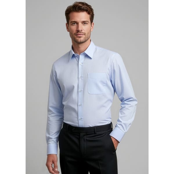 A light blue button-up shirt with a pocket, worn by a man standing against a neutral background.