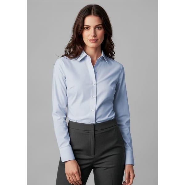 A light blue long sleeve button-up shirt for women, displayed on a model wearing grey trousers. The shirt features a collar and has a logo.