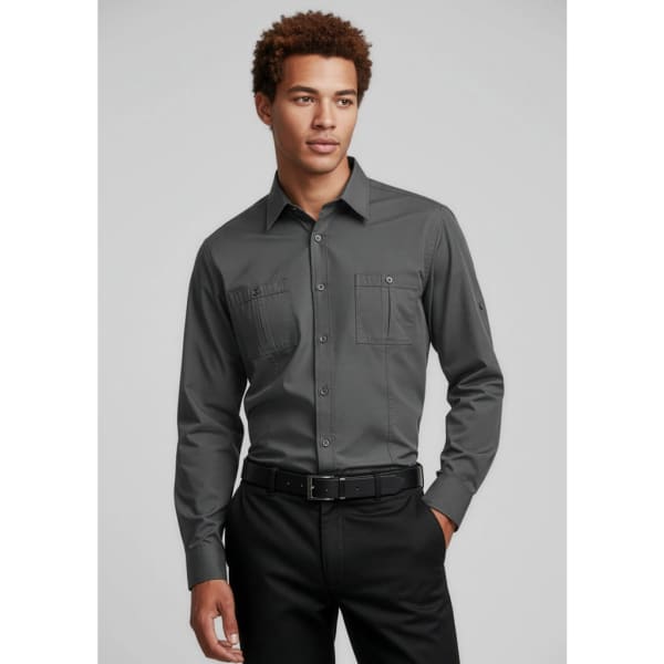 A long sleeve button-up shirt in grey with two front pockets and a logo, paired with black trousers.