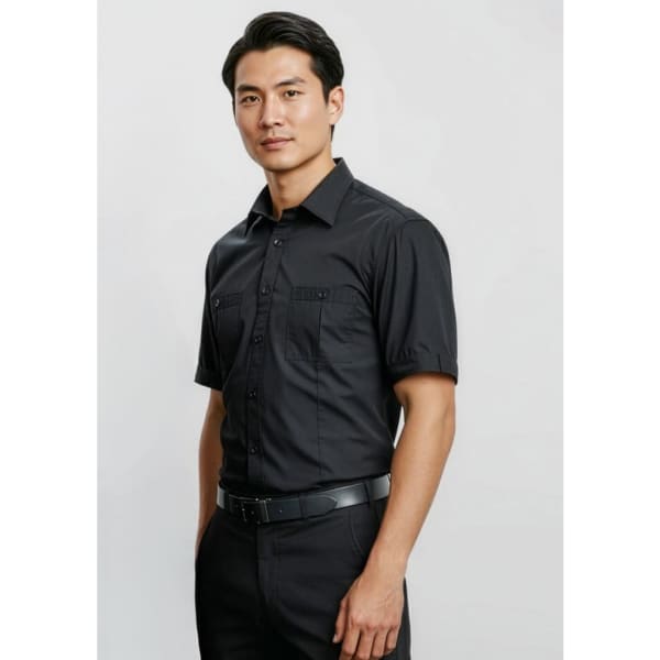 A black short sleeve button-up shirt featuring two chest pockets and a branded logo.
