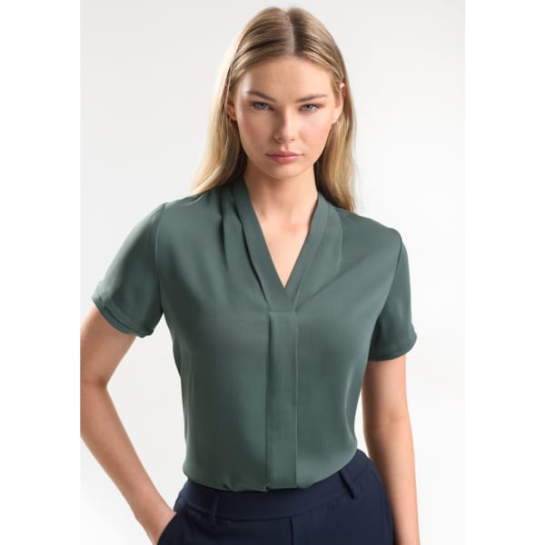 A short sleeve button-up shirt in a muted green colour, featuring a v-neck design and a subtle logo.