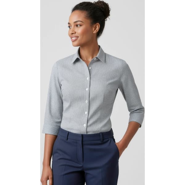 A woman wearing a grey and white checked 3/4 sleeve button-up shirt. The shirt has a collar and fitted shape.