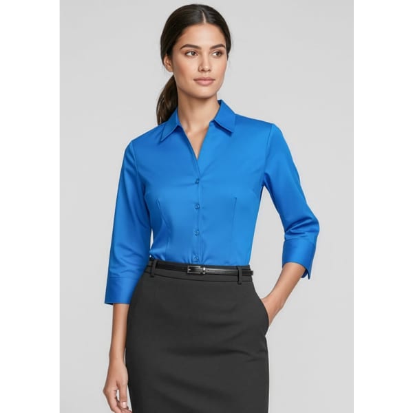 A blue 3/4 sleeve button-up shirt with a collar, styled with a black skirt. The shirt features a logo.