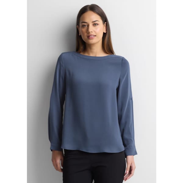 A blue women's boatneck top with long sleeves, featuring a smooth, flowing design. The top has a subtle branding logo.