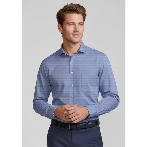 A blue long sleeve button-up shirt featuring a chest pocket and a subtle pattern, worn by a man.