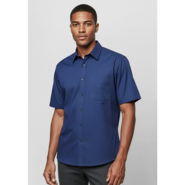A men's short sleeve button-up shirt in navy blue with a pocket and a logo.