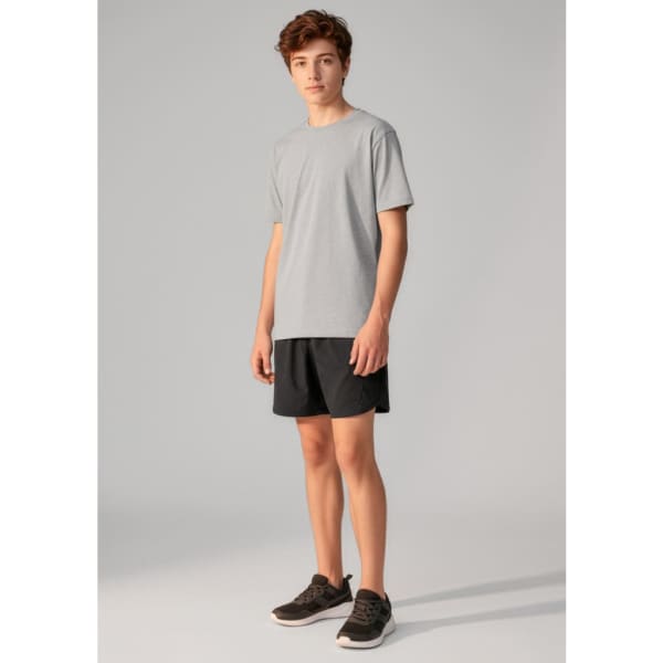 A pair of black sports shorts displayed on a model wearing a grey t-shirt and shoes. The shorts feature a logo.
