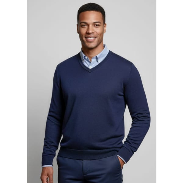 A navy men's knitted pullover with a V-neck design, paired with a light blue collared shirt. Includes a logo.