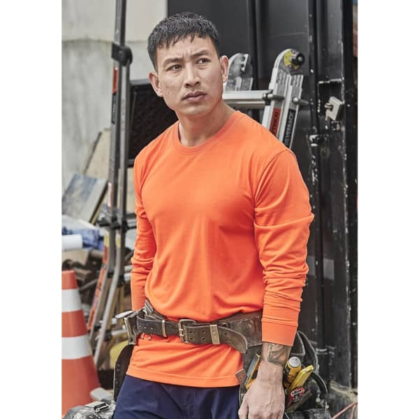 An orange long sleeve tee with a fitted design, suitable for safety wear, worn by a man on a construction site.