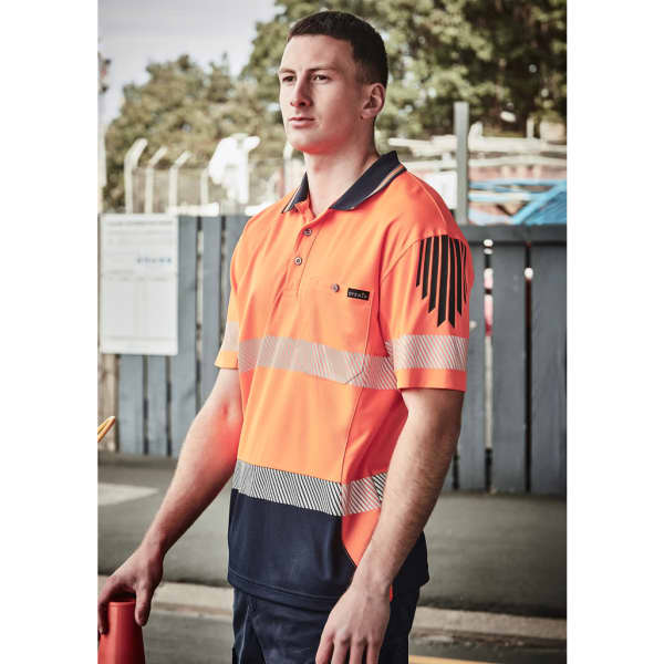 A polo shirt in hi-vis orange and navy, featuring segmented reflective tape and a logo on the chest.