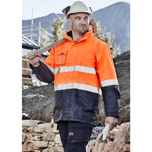A men's waterproof jacket in high visibility orange and navy, featuring reflective stripes and a logo.