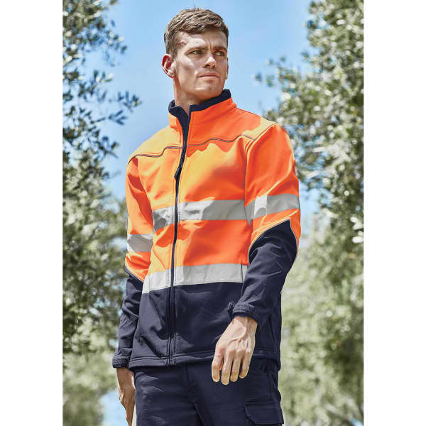 A unisex hi-vis softshell jacket in bright orange and navy, featuring reflective stripes, set against a natural background.