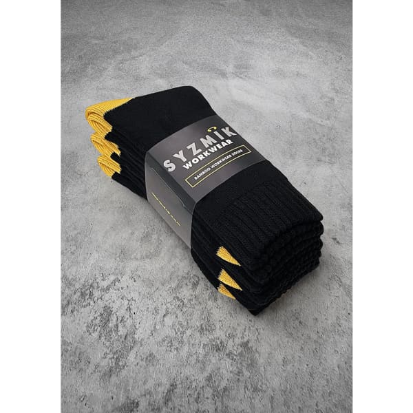 A pack of three black work socks with yellow accents, packaged and branded.