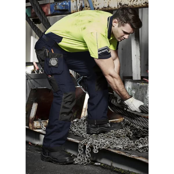 Men's ultralite multi-pocket pants in navy with multiple pockets, worn by a man in a high-visibility shirt.