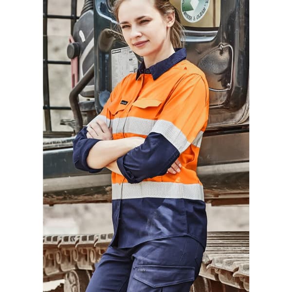 A long sleeve shirt featuring orange and navy colours with reflective tape, designed for rugged wear. Includes branding.