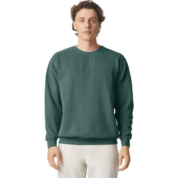 A green crewneck sweatshirt displayed on a model. The sweatshirt features a classic fit and ribbed cuffs.