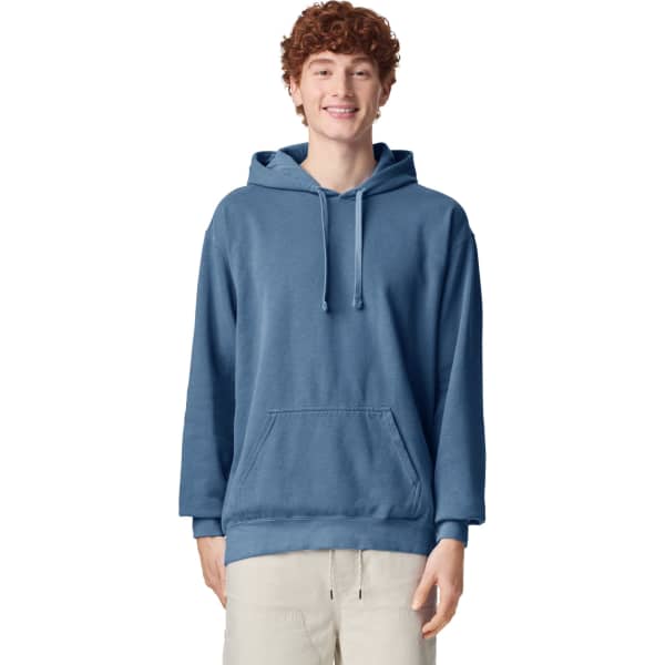 A blue adult hooded sweatshirt featuring a front pouch pocket and a logo, worn by a smiling model.
