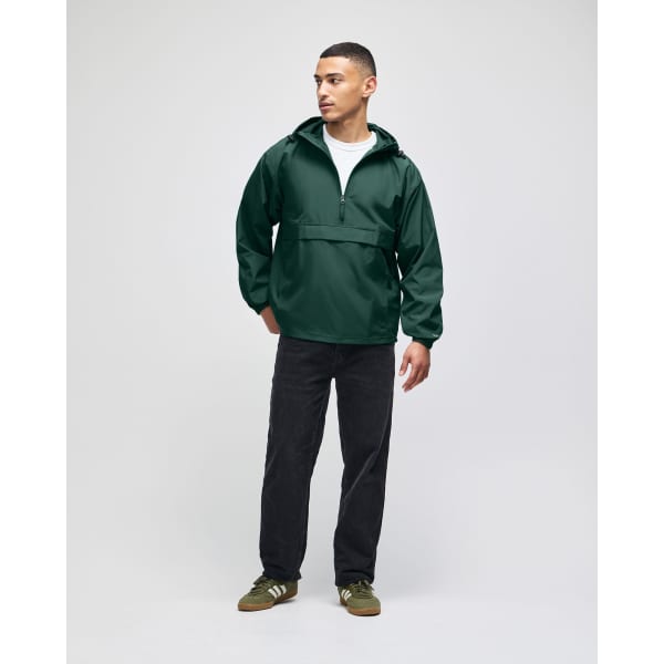 An olive green packable anorak jacket, featuring a hood and half-zip, worn by a model with black pants.