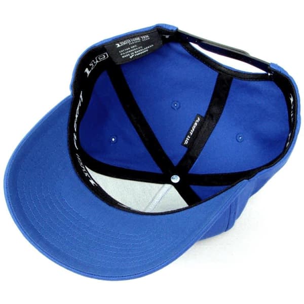 A blue cap with a structured design, featuring an interior view that reveals the lining and branding.