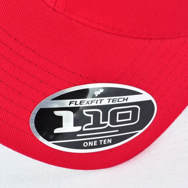 A red cap featuring a circular badge with branding, displaying "FLEXFIT TECH 110" in a silver design.