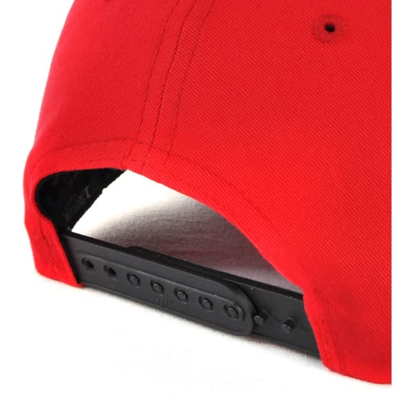 A red cap featuring a black adjustable strap at the back and a logo.