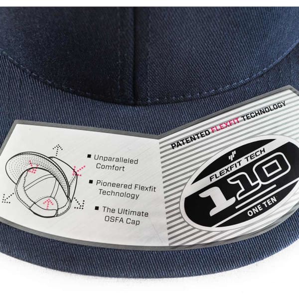 A navy blue Flexfit 110 cap featuring a tag with details about its patented technology and a logo.
