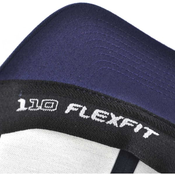 A close-up of a navy and grey trucker cap featuring a logo and the name "FLEXFIT 110" on the inner band.
