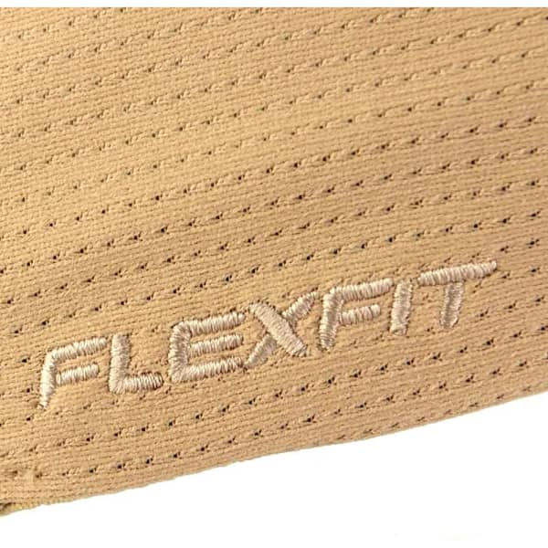 A close-up of a tan cap featuring a logo and a textured fabric pattern.