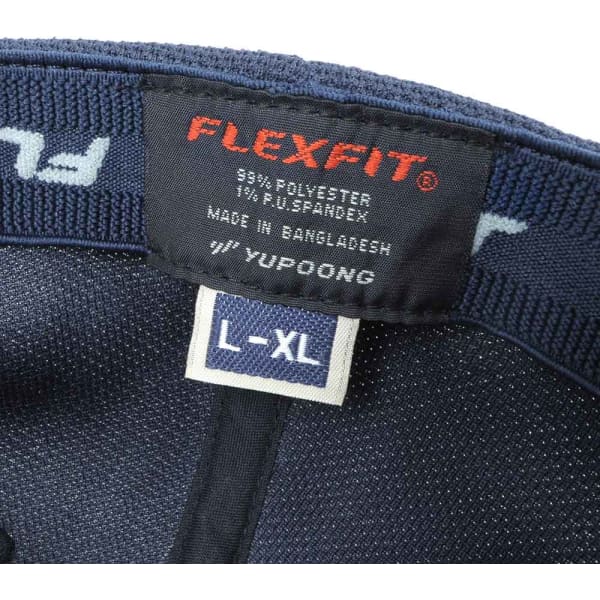 A dark navy cap featuring a lining tag with fabric composition details and a size label. The cap has a logo.