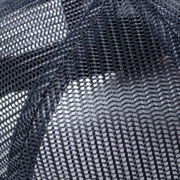 A close-up of a blue trucker cap featuring a mesh back and a solid front panel, with a logo present.