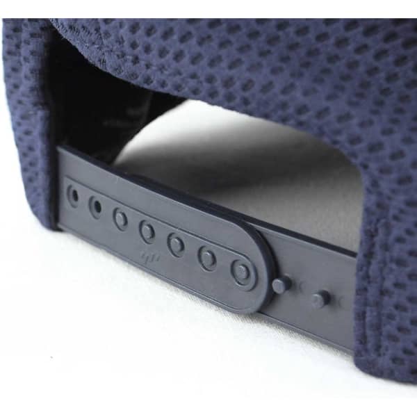 A close-up of a navy cap featuring a textured design and an adjustable strap with multiple notches.