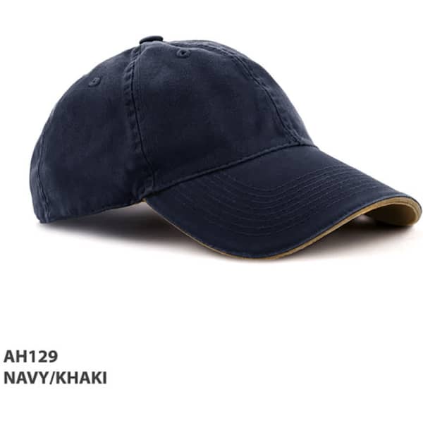 A navy and khaki enzyme washed cap with a curved peak and an adjustable strap. It features a logo on the front.